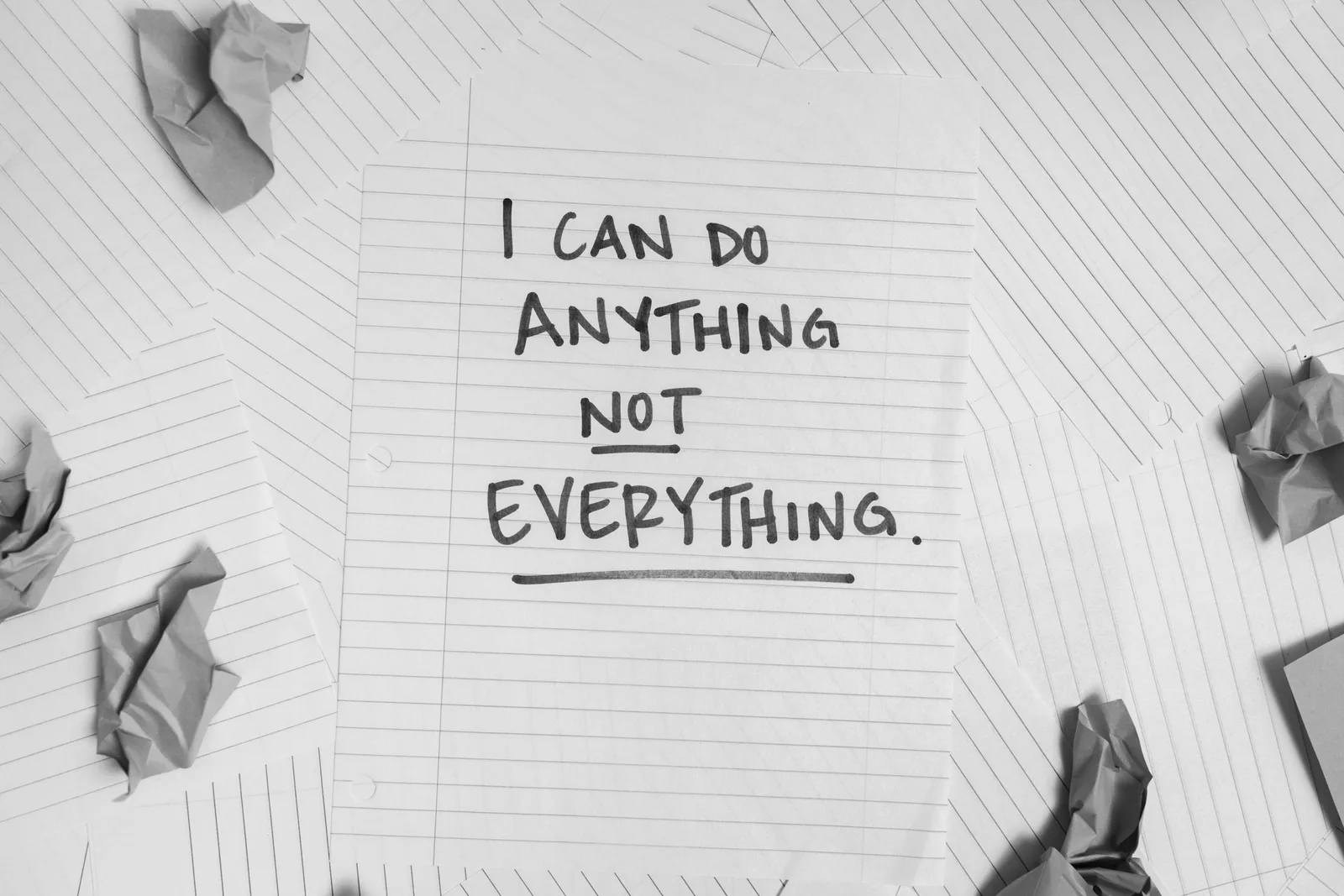 A motivational message on paper surrounded by crumpled sheets, symbolizing focus amidst chaos.